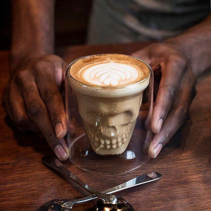 A cup of Skull Double-Layer Whiskey Glass from Maramalive™ is being poured into a glass.