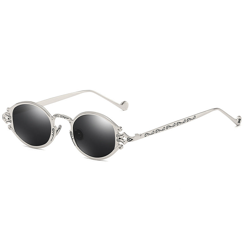 A pair of Maramalive™ Steampunk Gothic Oval Frame Carved Sunglasses with black lens and a metal frame.