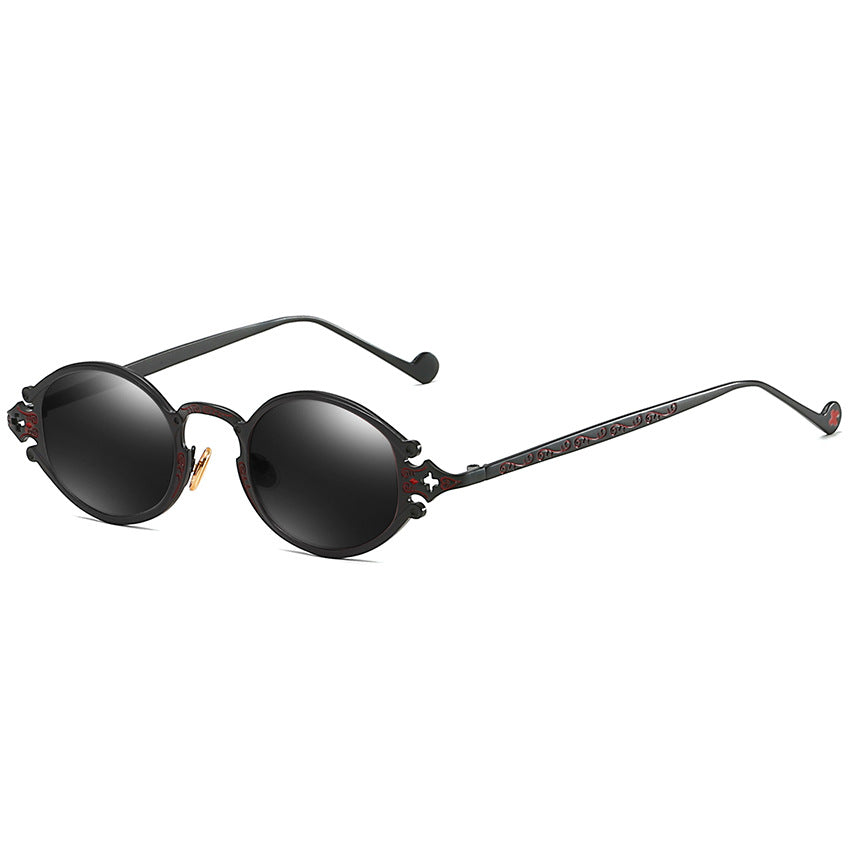 A pair of Maramalive™ Steampunk Gothic Oval Frame Carved Sunglasses with black lens and a metal frame.