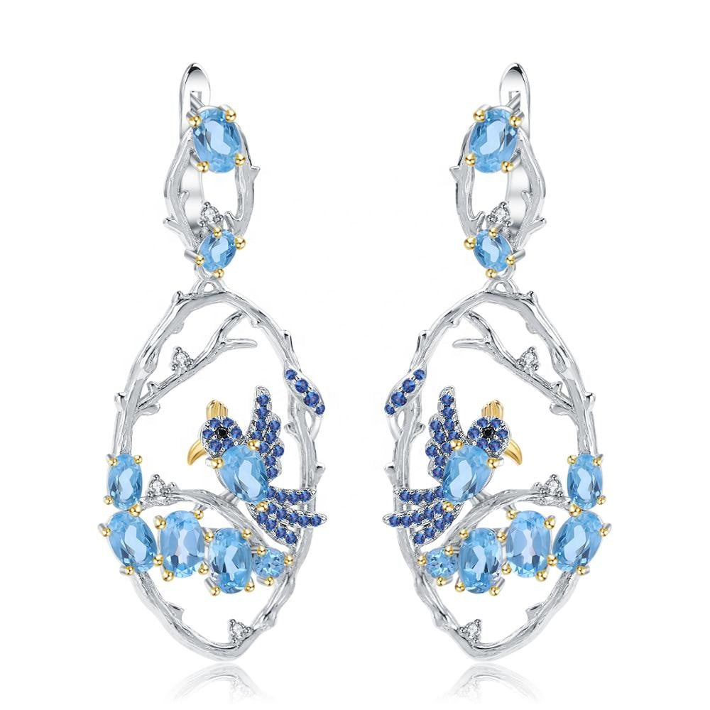 A pair of Maramalive™ Blue Topaz Sterling Silver Fashion Earrings with blue topaz and sapphires.