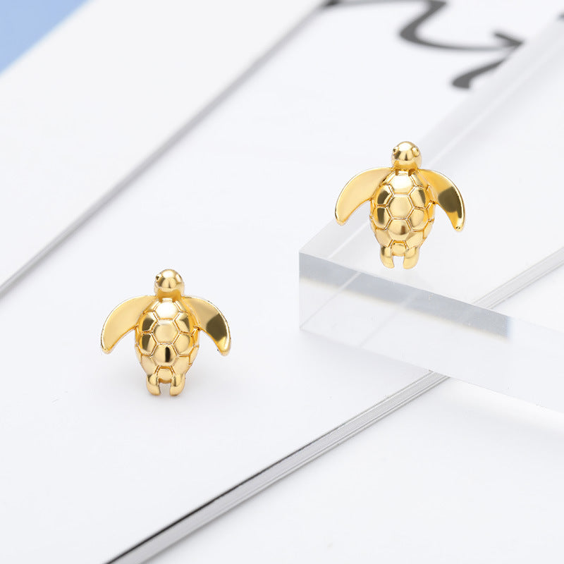 A pair of Maramalive™ Seaside Turtle Earrings.