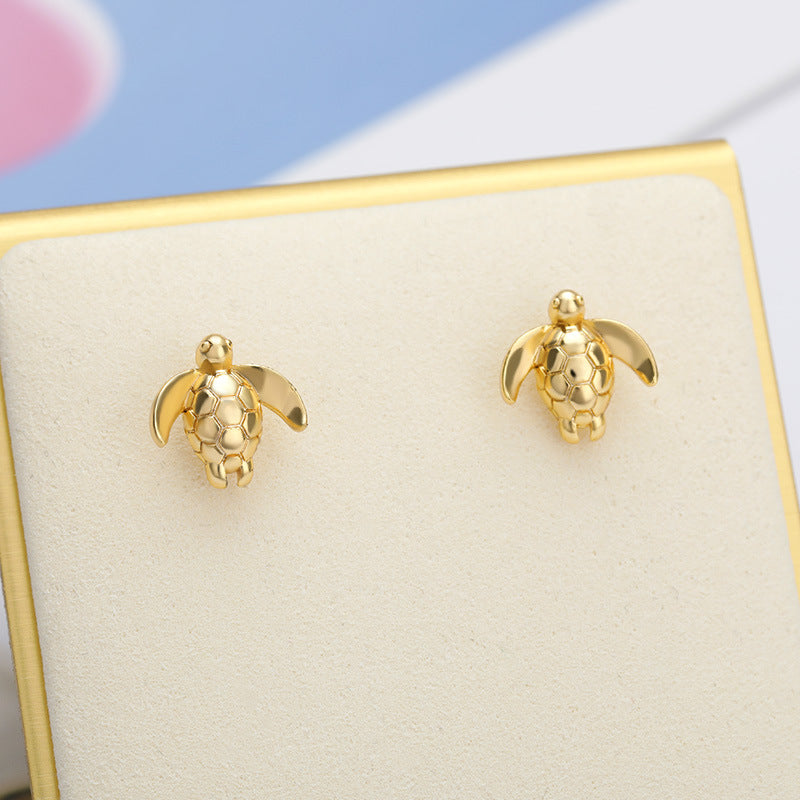 A pair of Maramalive™ Seaside Turtle Earrings.