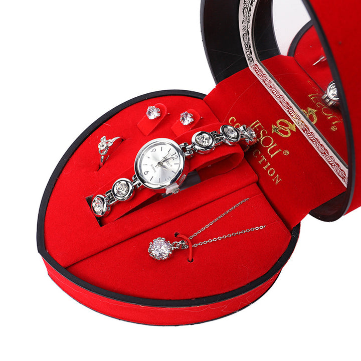 A red heart-shaped box with a Maramalive™ Radiant Jewelry Ensemble to Dazzle and Delight - Beautiful Jewelry set including Zircon Earrings, Ring, Pendant, and Watch inside.