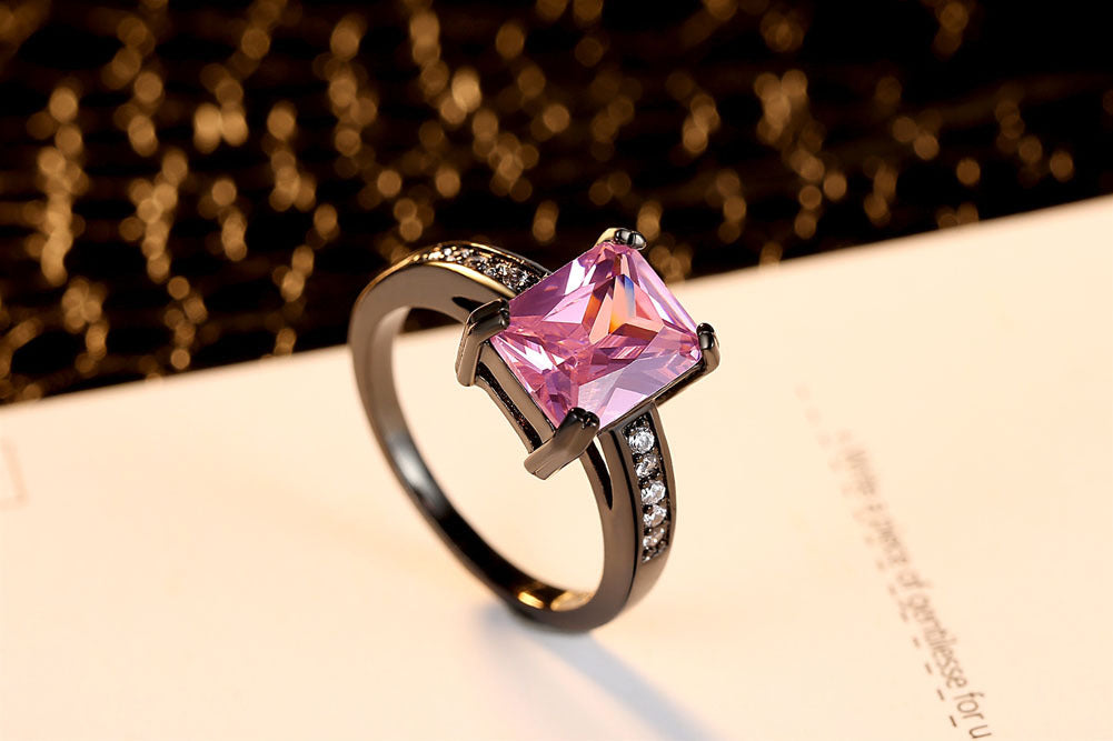 A Maramalive™ pink topaz ring with black diamonds.