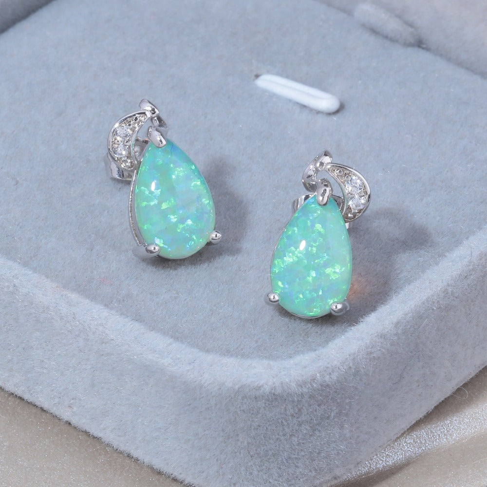 A pair of Light Green Water Drop Earrings by Maramalive™ with green opal and diamonds.