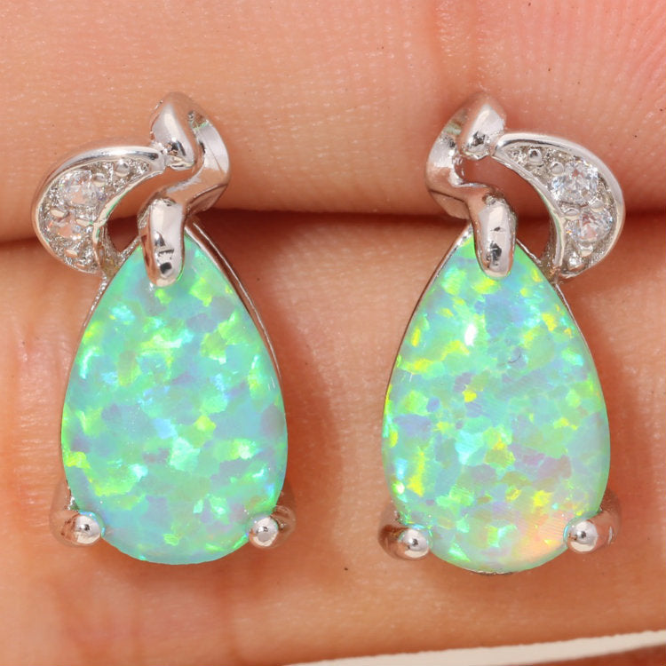 A pair of Light Green Water Drop Earrings by Maramalive™ with green opal and diamonds.