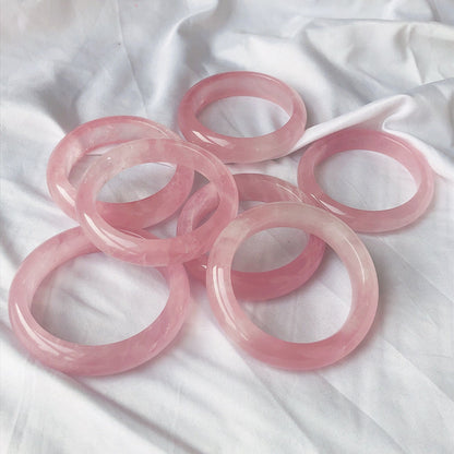 Six Rose Quartz Crystal Bracelets on a white bed by Maramalive™.