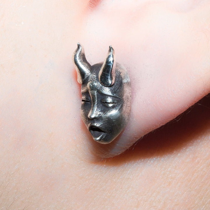 A pair of Gothic Horned Demon Baby Face Stud Earrings Vintage Devil Prajna by Maramalive™ on a white surface.