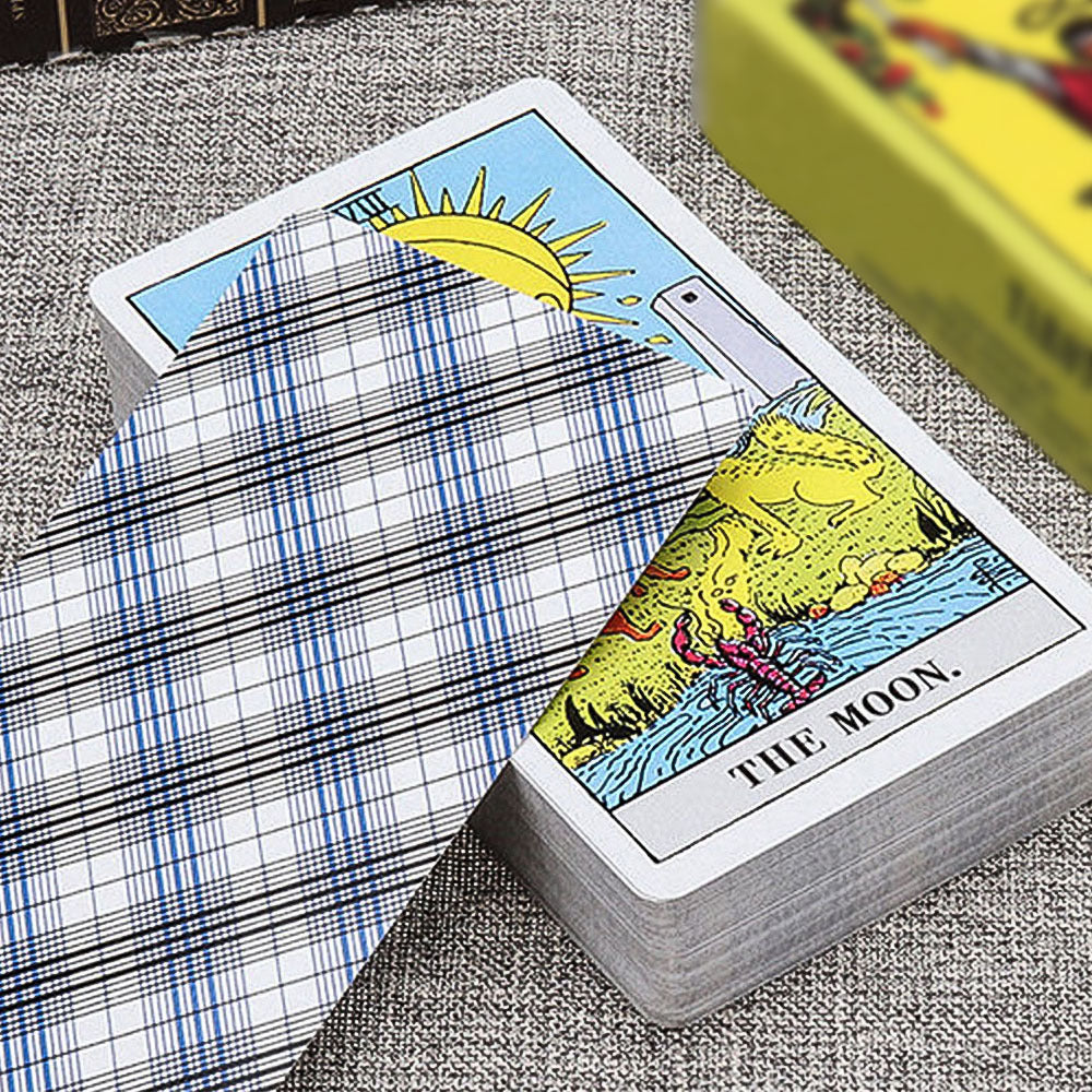 An English Tarot Card Novice Divination Puzzle is sitting on a table next to a plaid tie.