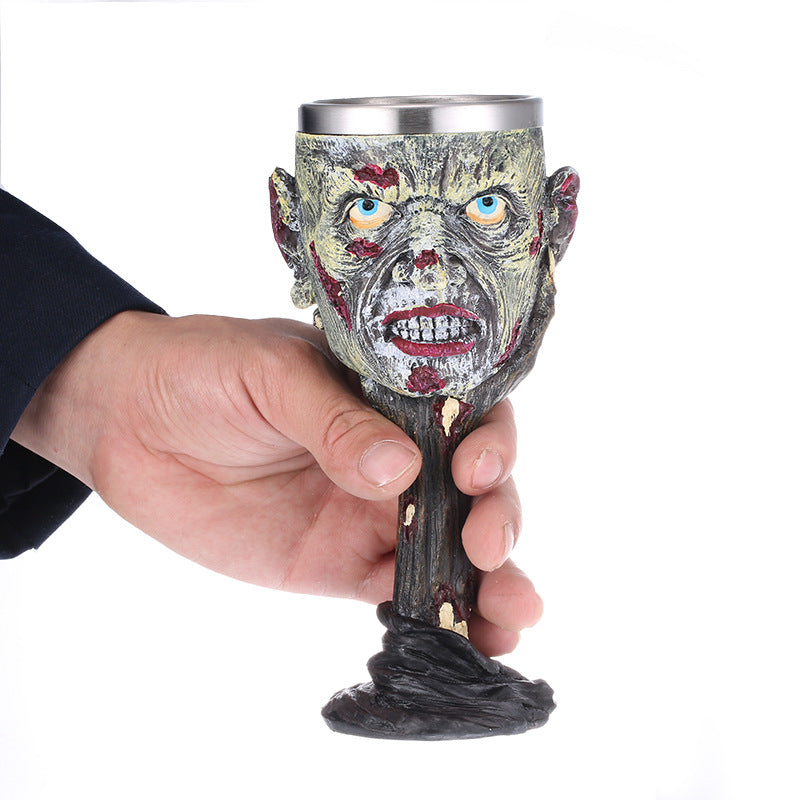 A person holding a Skull Wine Glass with the Maramalive™ brand name on it.