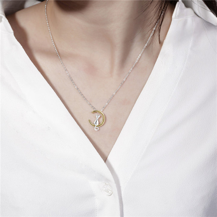 A woman wearing a white shirt and a Moon Cat Choker Necklace: Minimalist Pet Charm Jewelry Set for Women by Maramalive™ that has a crescent moon pendant.