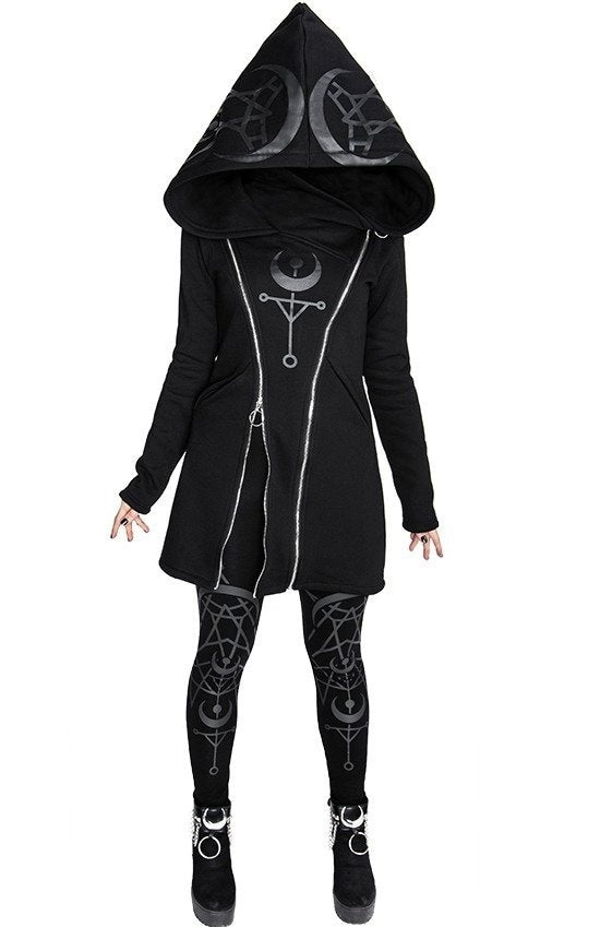 Person wearing a black Maramalive™ Punk Style Printed Long Sleeved Hooded Double Zipper Sweater Long with a large hood, featuring crescent moon and circle symbols, and matching intricate patterned leggings and shoes reminiscent of a chic ladies' sweater style.