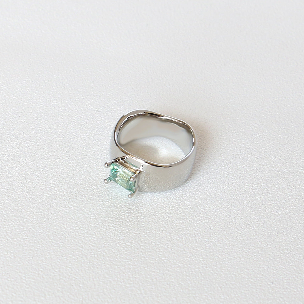 A Cold Wind Couple Ring with a green stone in the middle by Maramalive™.