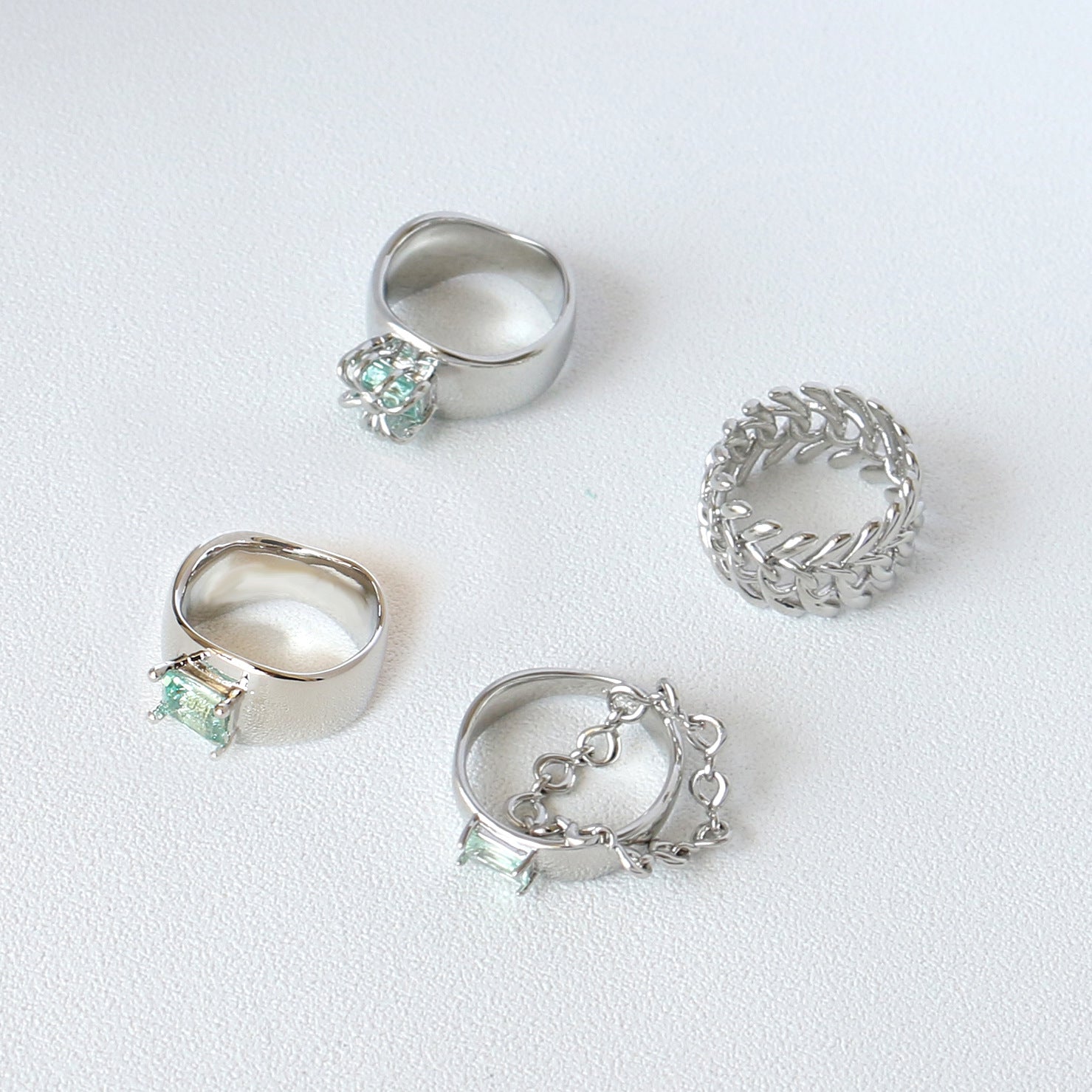 A Cold Wind Couple Ring with a green stone in the middle by Maramalive™.