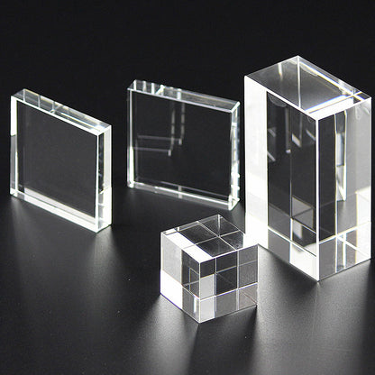 Two Transparent Crystal Glass Cubes on a black surface.