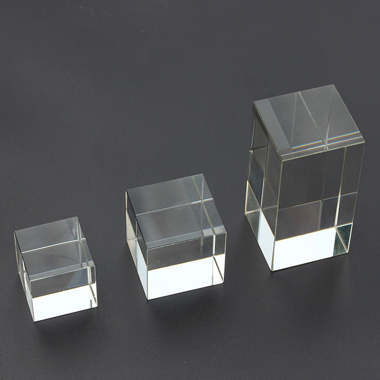 Two Transparent Crystal Glass Cubes on a black surface.