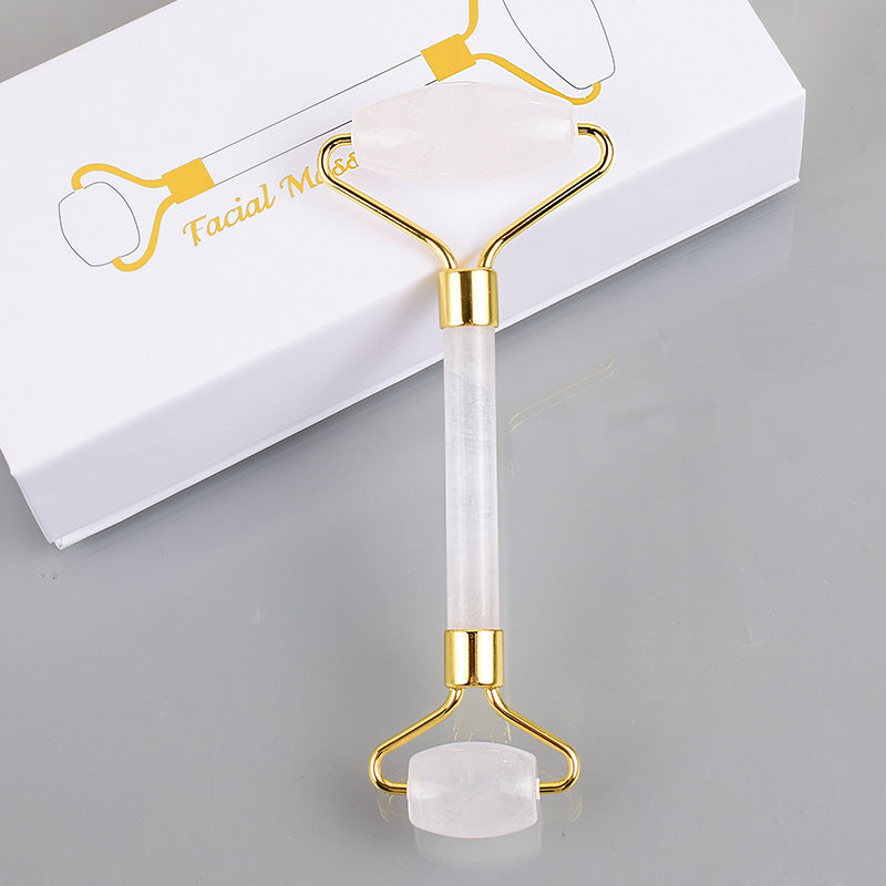 A gift box with a Maramalive™ Stone Roller Massager Crystal Beauty Instrument Transparent Crystal and a gold plated spatula.