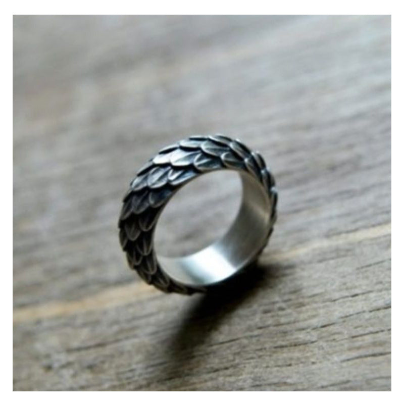 A Maramalive™ silver ring with leaves on it.
Discover the Alluring Beauty of the Retro Amazing Dragon Scale Ring by Maramalive™.