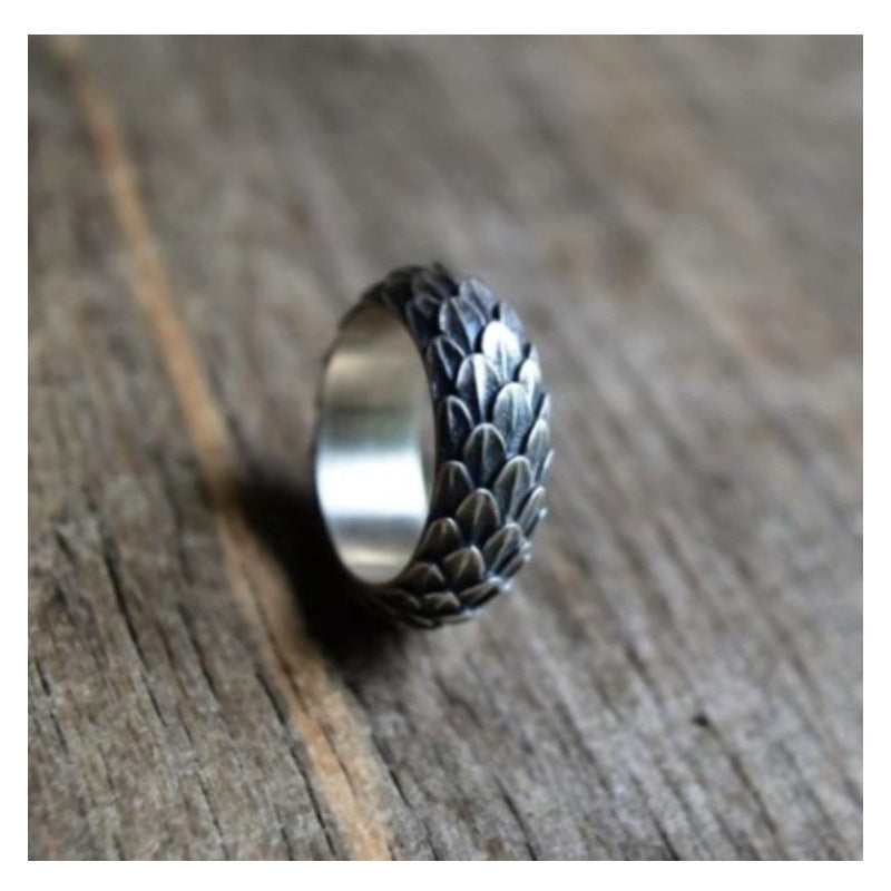 A Maramalive™ silver ring with leaves on it.
Discover the Alluring Beauty of the Retro Amazing Dragon Scale Ring by Maramalive™.