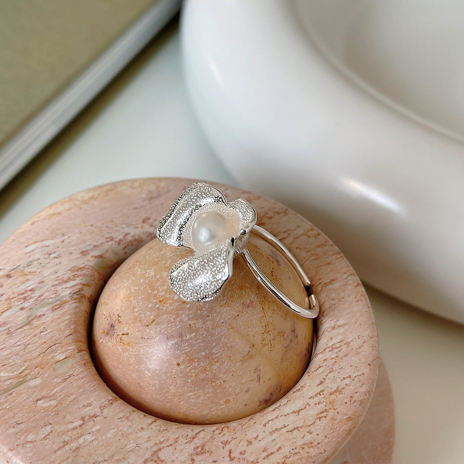 An Irregular Flower Pearl Ring with a pearl in the middle by Maramalive™.