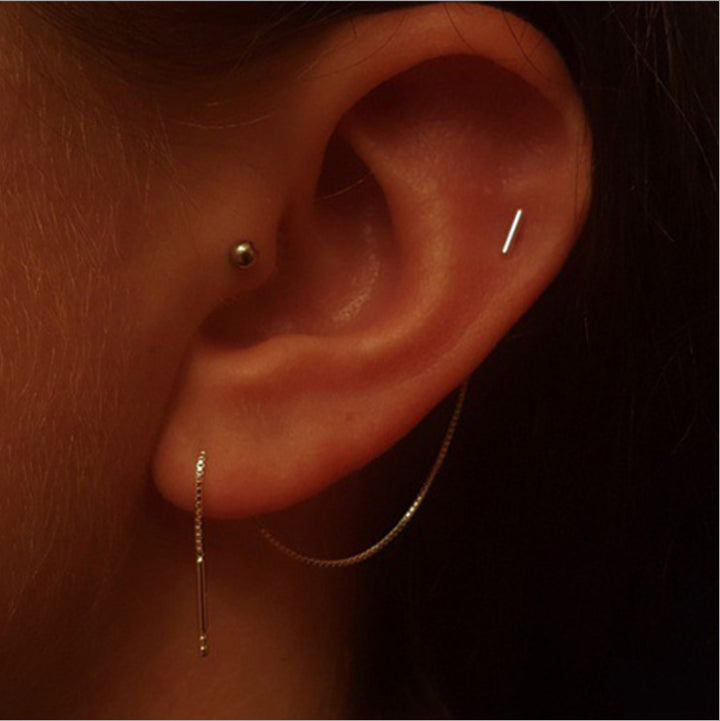 A close up of a woman's ear with Maramalive™ Tassel Threader Earrings.