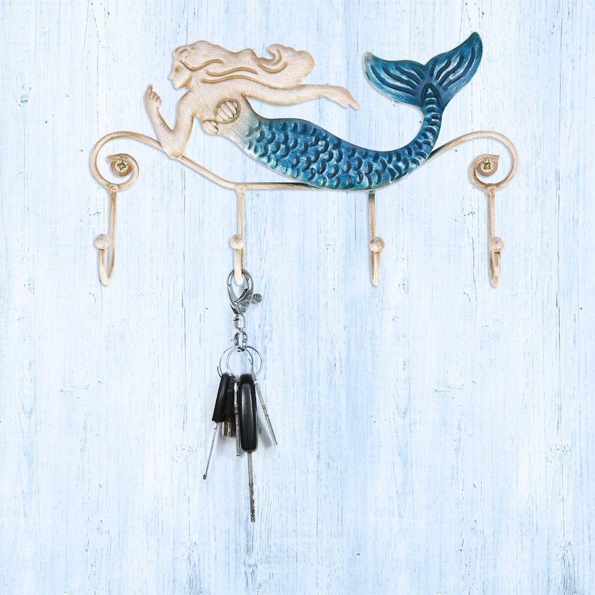 A Mermaid Retro Living Room Wall Hook with keys hanging on a hook from Maramalive™.