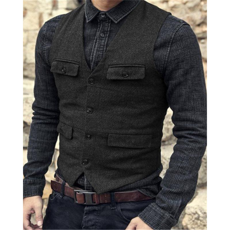 A person wearing a dark denim shirt with Maramalive™ European And American Men's Vest Casual Solid Color Herringbone Vest and dark jeans, all in a sophisticated British style, stands with hands in pockets.