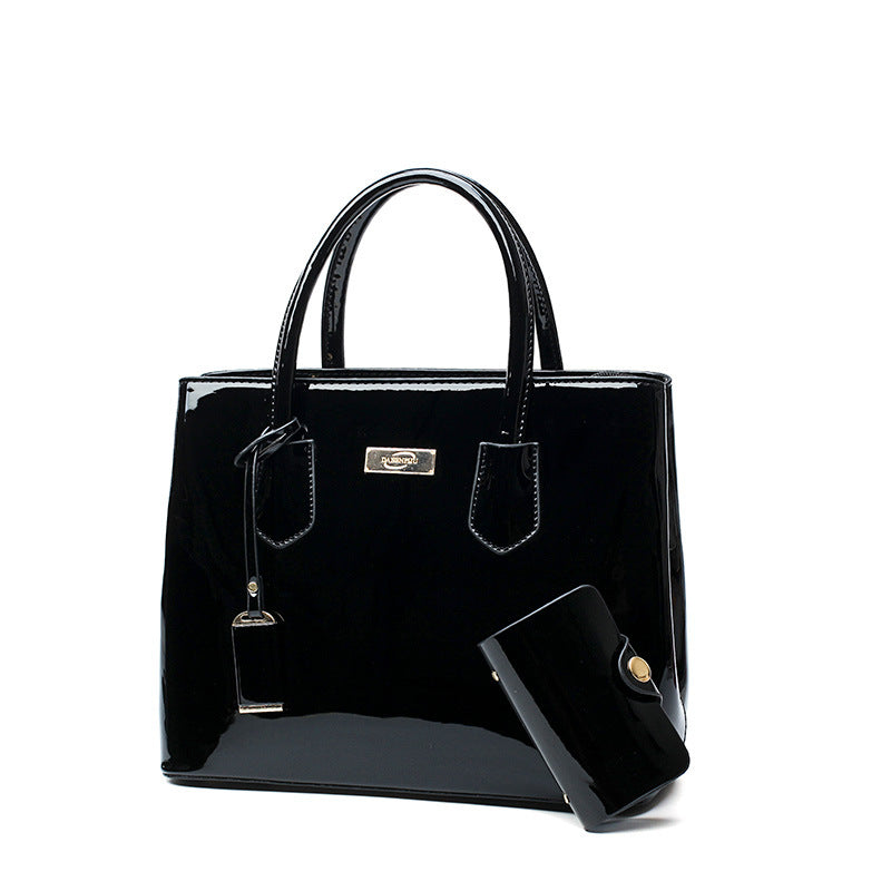 A Patent Leather bag with a metal handle by Maramalive™.