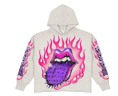 A white hoodie featuring a vibrant design of a purple spiked tongue and pink flaming lips on the front, with similar flame graphics on the sleeves. The Maramalive™ Popular Skull Print Design Hoodie Retro Street Gothic Style blends gothic street style with urban edge, making it the perfect addition to any skull hoodie collection.