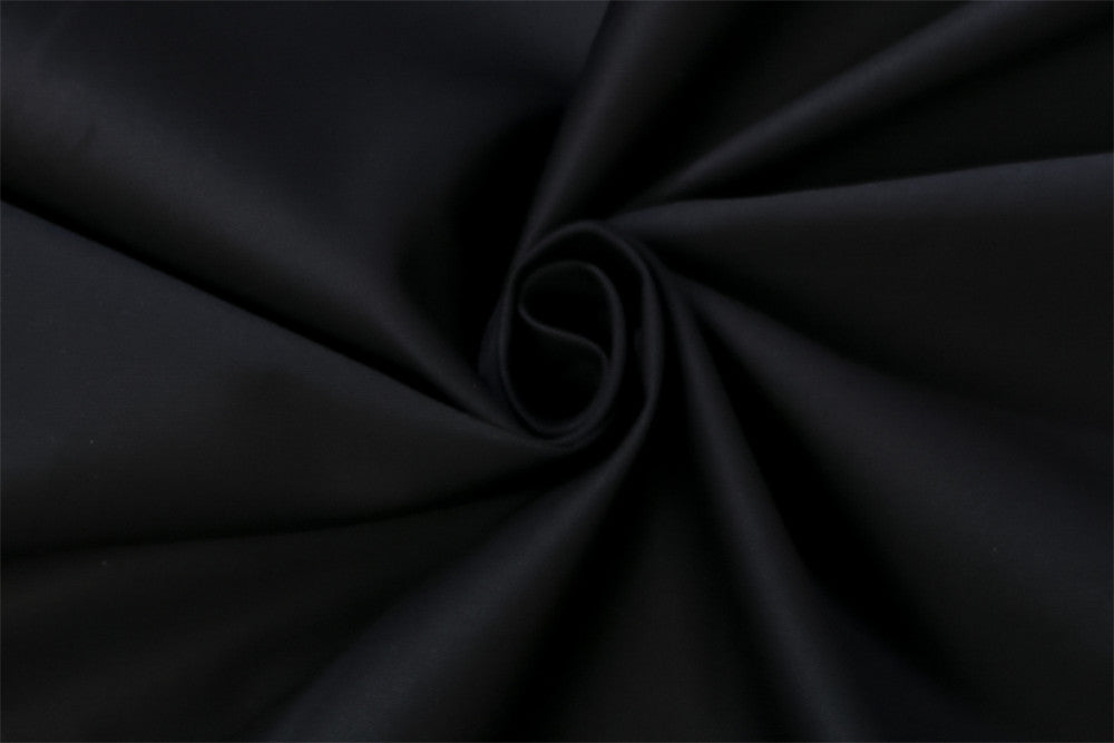 A close-up of black fabric with a swirl pattern on a Maramalive™ men's printed long-sleeve shirt, demonstrating its texture and printed design.