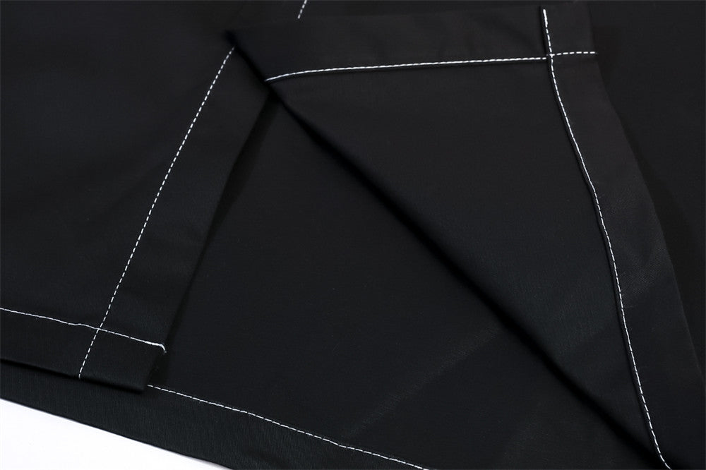 Close-up of neatly folded black fabric with visible white stitching along the edges. The fabric appears to overlap itself, showcasing the stitching details, perfect for a versatile shirt or Maramalive™ Men's printed long-sleeve shirts | Men's dress shirts.