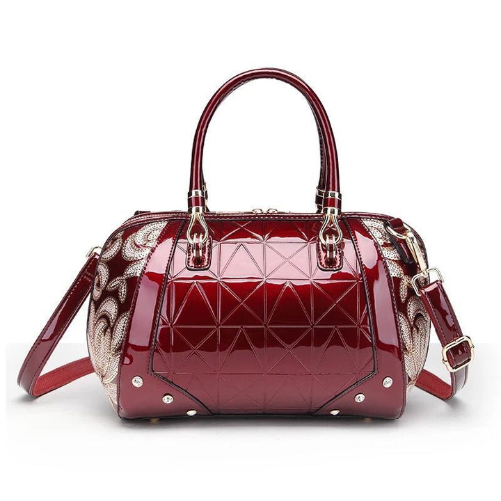 A burgundy Patent leather Boston handbag with a geometric pattern featuring a unique bag shape and fabric texture by Maramalive™.