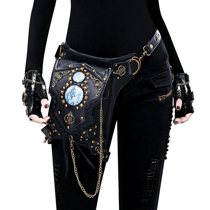 A woman is holding a black Maramalive™ Steampunk One-shoulder Diagonal Bag Trendy Fashionable Practical Use Bag with chains.