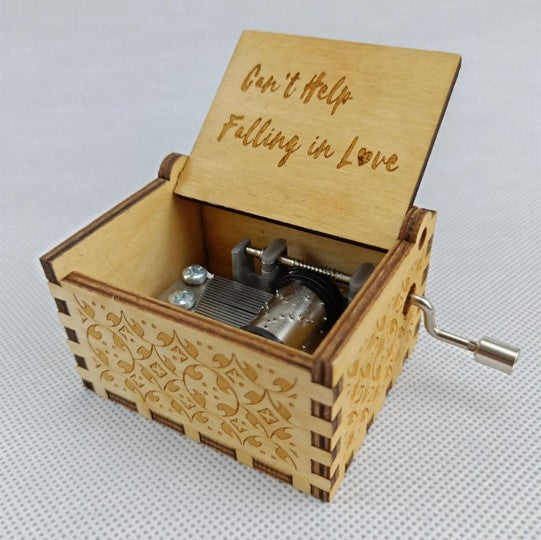 An Antique Carved Wooden Hand Crank Music Box with the word queen on it, made by Maramalive™.