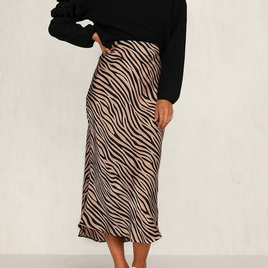 A woman wearing a black sweater and zebra print Maramalive™ leather dress skirt made of polyester fiber.