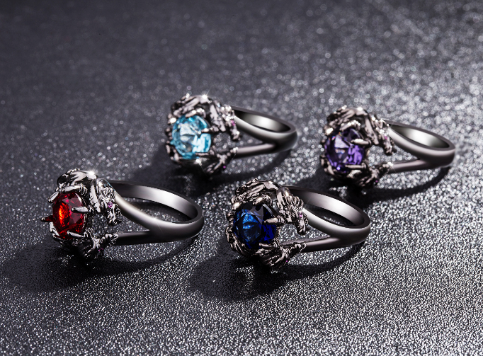 A set of four Tiamat Rings by Maramalive™ with different colored stones.