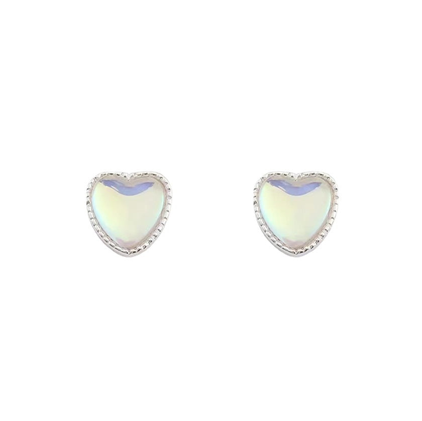 A woman wearing a pair of Maramalive™ Sterling Silver Needle Super Fairy Small Opal Love Heart Stud Earrings.