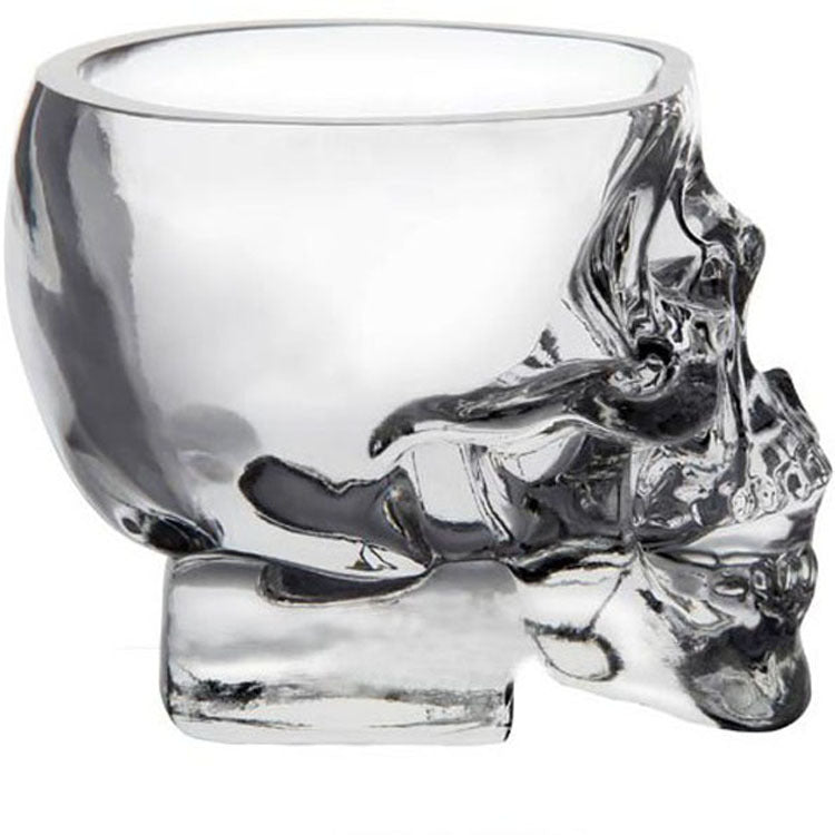 A glass of water is being poured into a Maramalive™ Skull Spirit Glass.