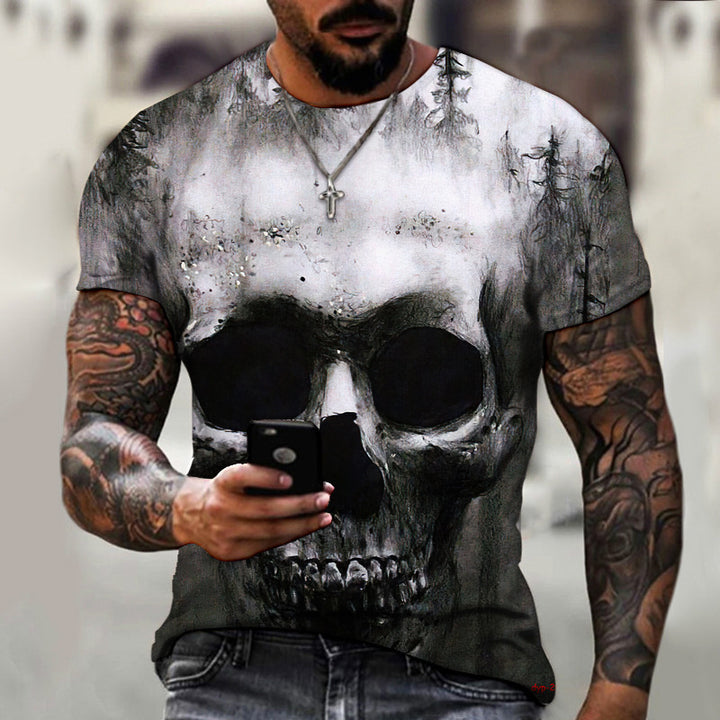 A man with tattooed arms wears a Maramalive™ New Summer Horror Skull 3D Men's T-shirt and holds a smartphone. He also wears a cross necklace.