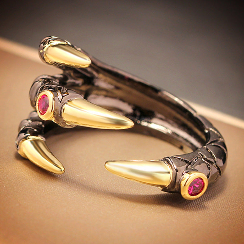 A Dragon Claw Ring from Maramalive™ with claws and a pink stone.