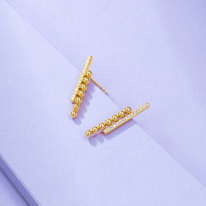 A pair of Maramalive™ Gold-Plated Minimalist Earrings on a purple background.