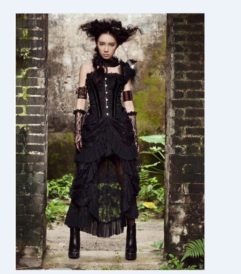 A woman in a Gothic Long Skirts Banquet Birdtail Lace Dress from Maramalive™ is posing in front of a brick wall.