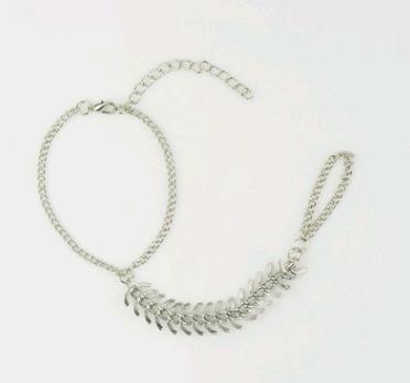 A Punk Fish Bone Bracelet by Maramalive™ with a chain on it.