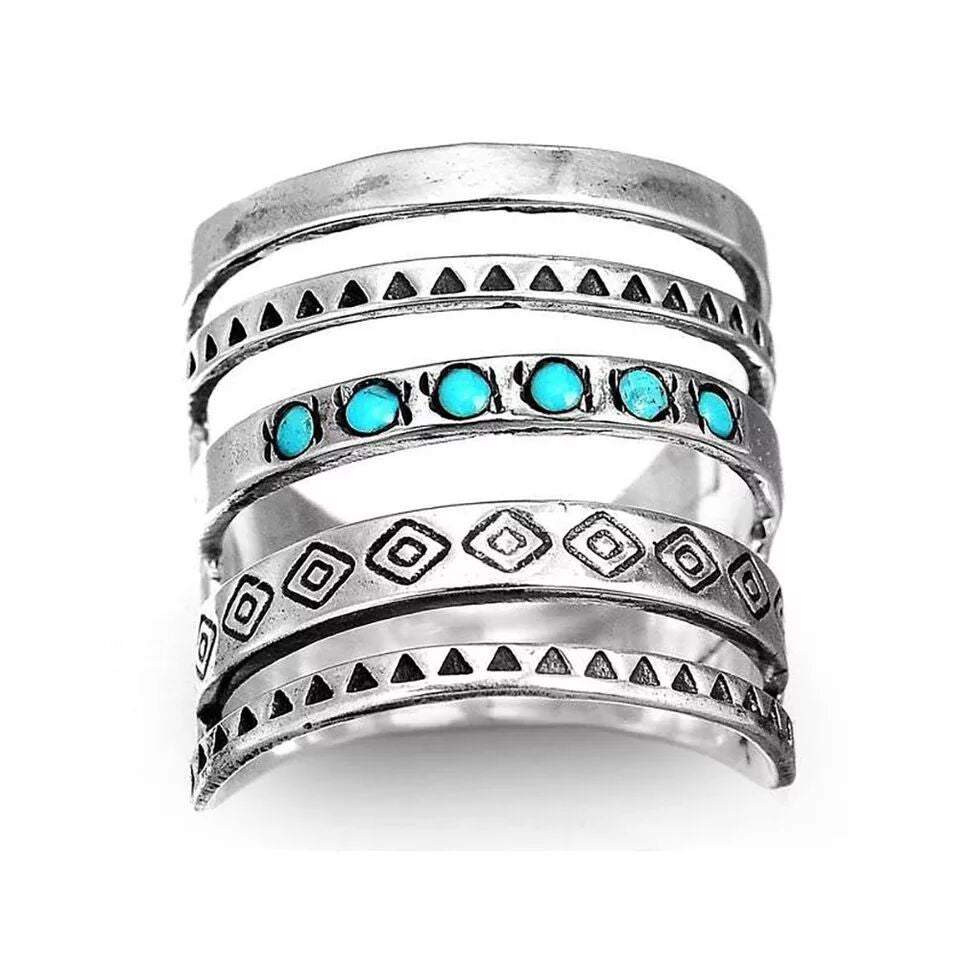 A woman wearing a sweater and a pair of Maramalive™ Fashion Hollowed-out Vintage Turquoise Rings.