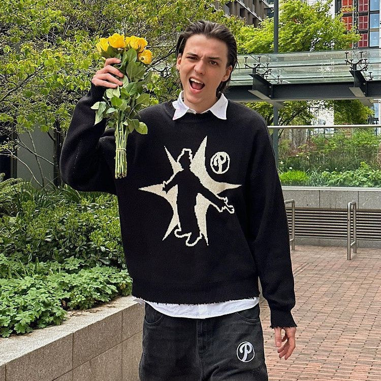 Person holding a bouquet of yellow roses, wearing a Maramalive™ Hip-Hop Street Gothic Print Knitted Sweater, enthusiastically posing outdoors in an urban setting, embodying street fashion.