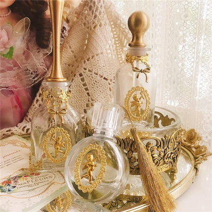 A set of Vintage French Angel Perfume Bottles on a tray with a doll on it by Maramalive™.