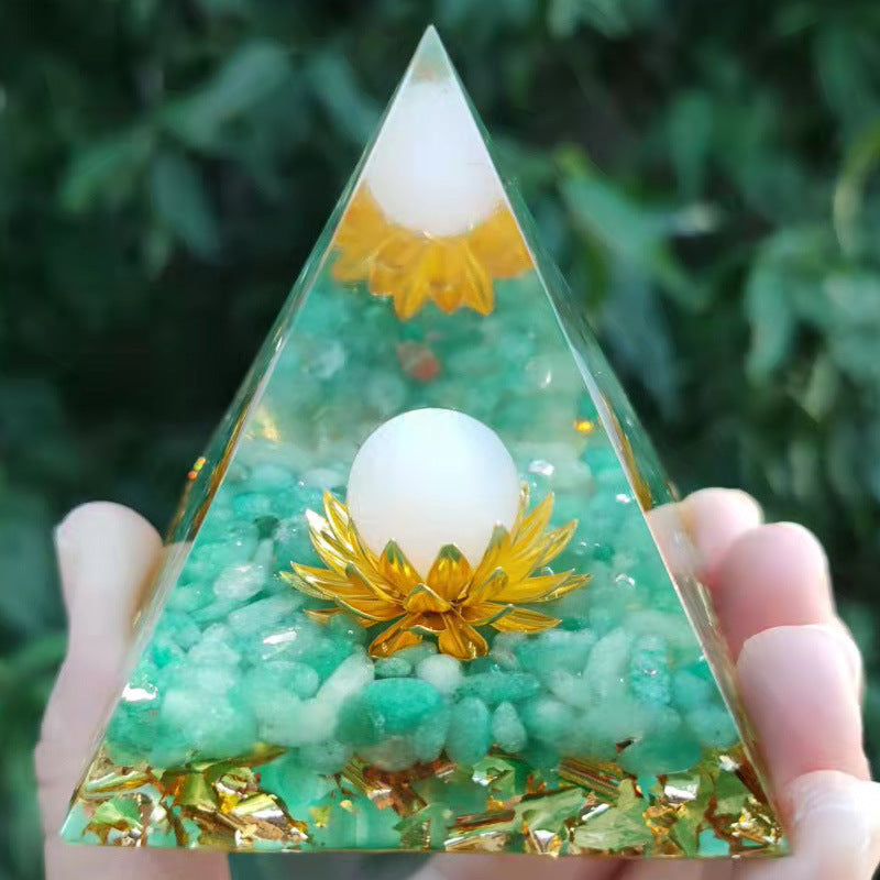 a hand holding a small Crystal Ball Pyramid Crystal Gravel Epoxy Resin shaped object by Maramalive™.