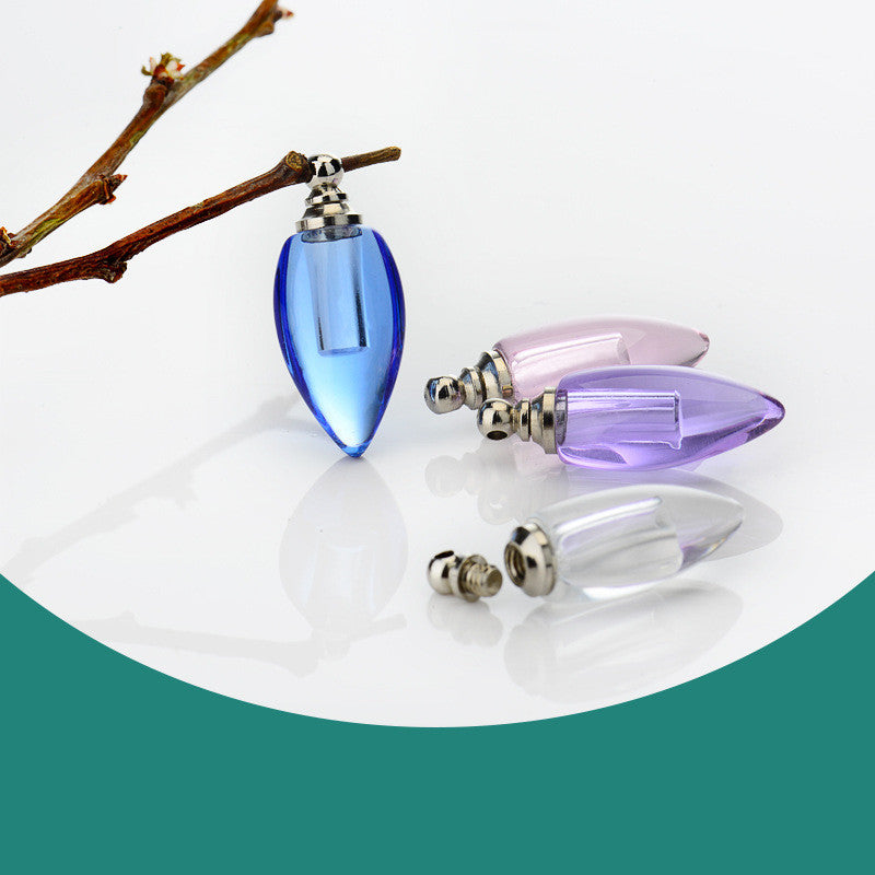 An Ordinary Rice Carving Crystal Bottle Essential Oil Pendant from Maramalive™ sits on a branch.