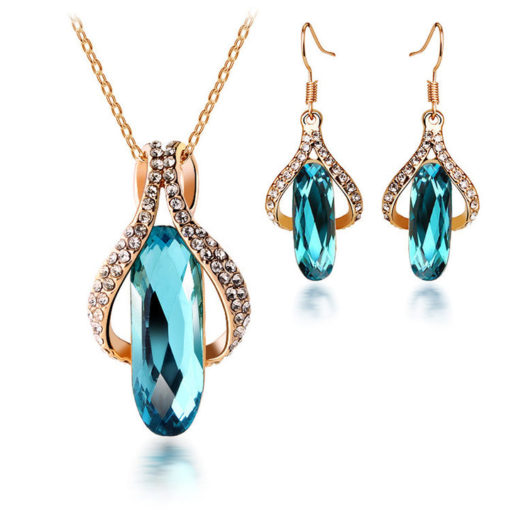 A Gorgeous Peacock Blue diamond earrings and pendant set by Maramalive™ on a black background.