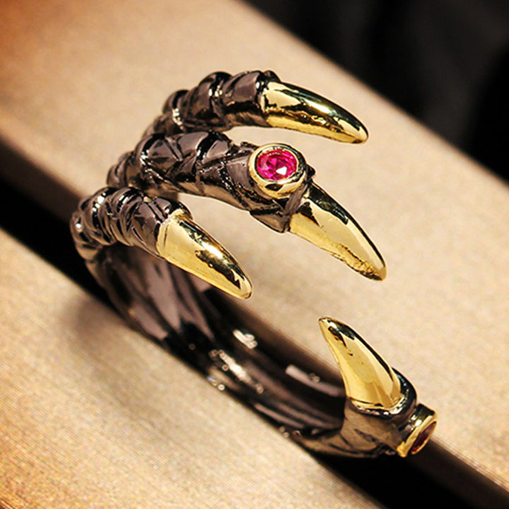 A Dragon Claw Ring from Maramalive™ with claws and a pink stone.